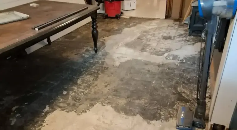 Wet basement floor with drying equipment running in Woodside