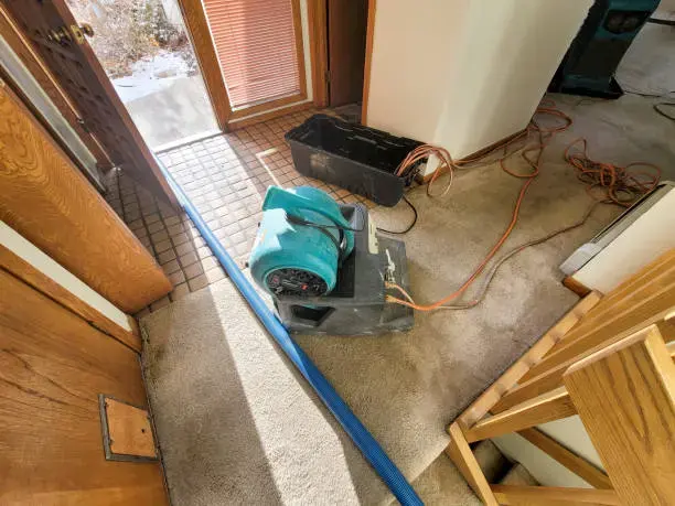 Air mover drying a wet hallway floor in a Woodside home